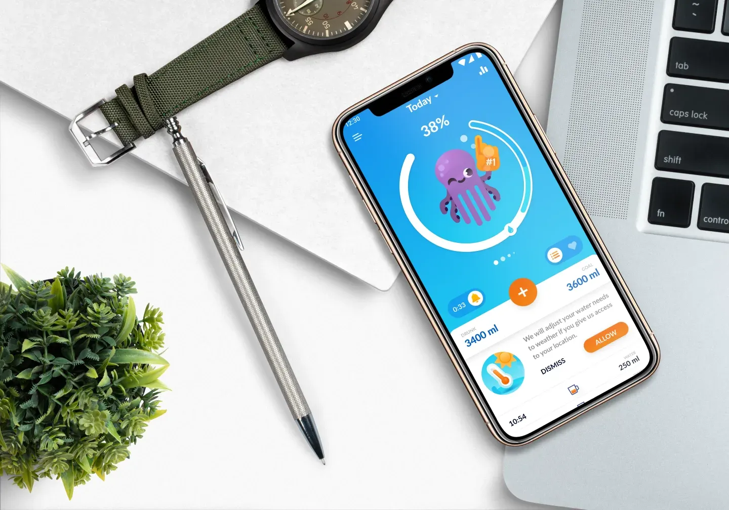 Smartphone affichant une application de suivi d'eau, à côté d'une montre